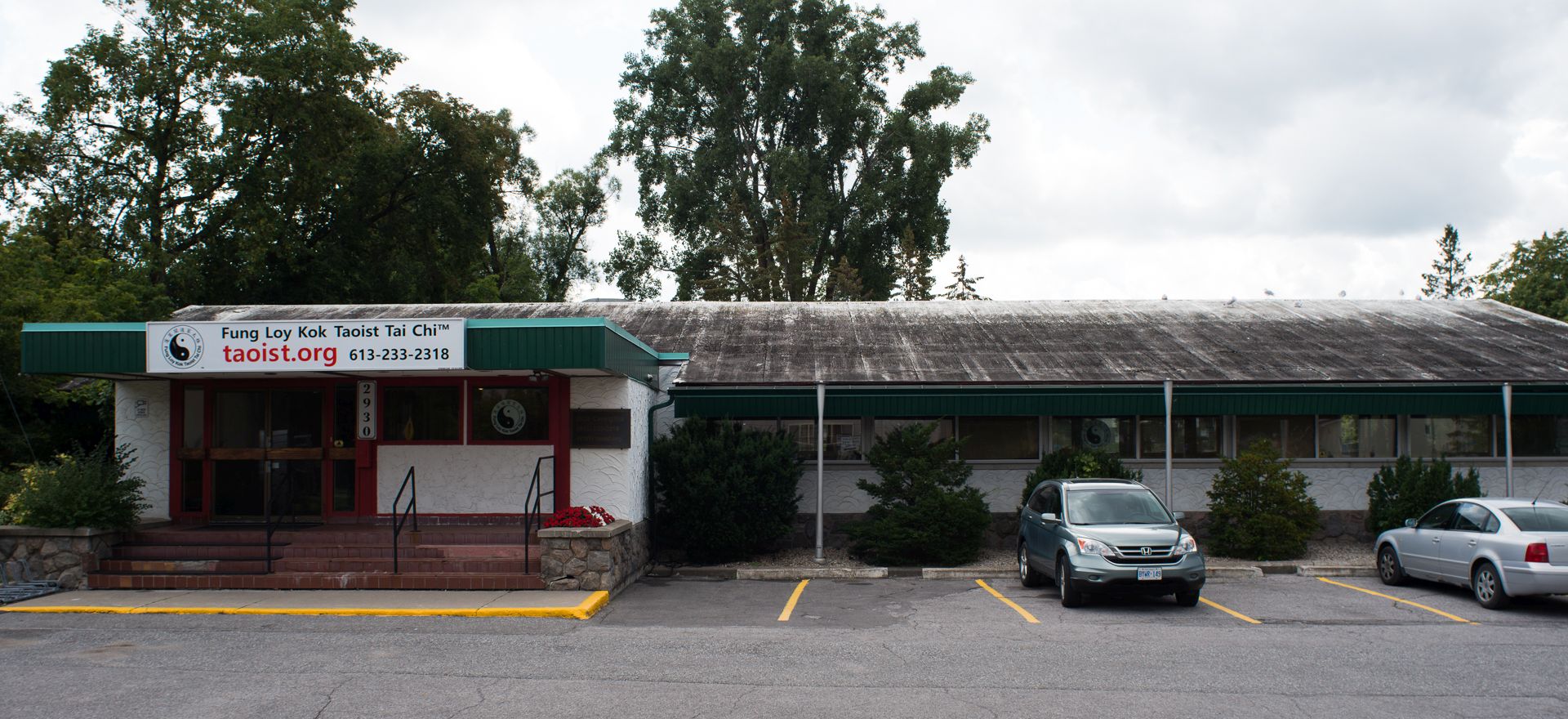 Exterior view of a one-storey white stucco building.